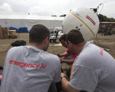 Aid workers installing a satellite communications terminal in Kathmandu, Nepal. Photograph courtesy of SES.