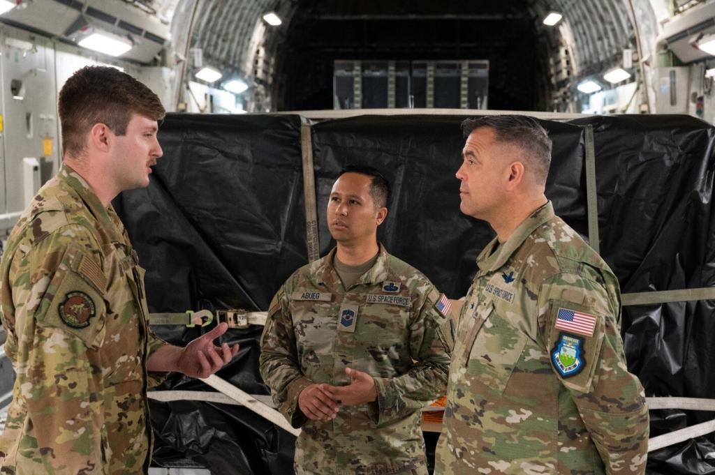 Staff Sgt. Kyle Wilson, 736th Aircraft Maintenance Squadron flying crew chief out of Dover Air Force Base, Delaware, speaks with Brig. Gen. Anthony Mastalir, U.S. Space Force-Indo-Pacific commander, and Chief Master Sgt. Leomel I. Abueg, U.S. Space Force-Indo-Pacific Component-Field Command Senior Enlisted Leader, Joint Base Pearl Harbor-Hickam, Hawaii, May 9, 2023. SSC. Credit: Tech. Sgt. Hailey Haux