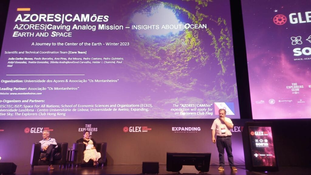 Image: Ricardo Conde and Yvette Gonzalez on stage at the GLEX Summit as Professor João Carlos Nunes announces the upcoming Azores|CAMões Analog Research Mission. Credit: Expanding