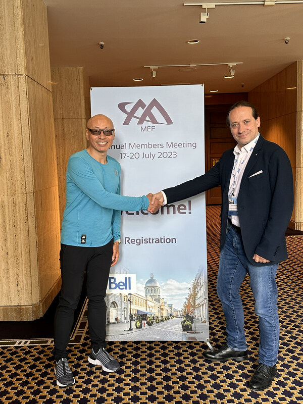 MEF President Nan Chen (left) shakes hands with Konrad Nieradka, vice president for products and services, Rivada Space Networks. Credit Rivada Space 