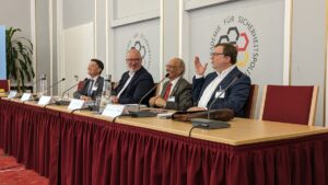 Welcome remarks of Professor Stephan Hobe, Director of the Institute of Air, Space and Cyber Law of the University of Cologne. He is joined by Dr. Jan Stöß, Director General for Legal Affairs of the German Ministry of Defence, and Co-Editors Ram Jakhu and Steven Freeland in welcoming over 50 participants to the MILAMOS Conference in Berlin. Credit Institute of Air and Space Law