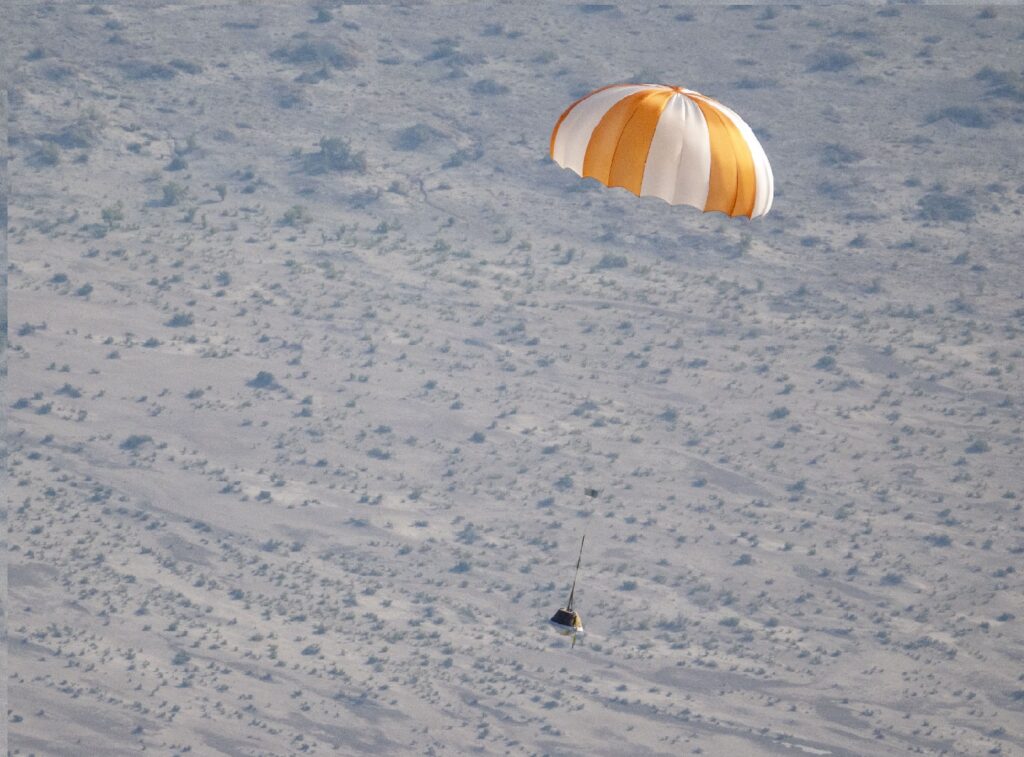 A training model of the sample return capsule is seen is seen during a drop test in preparation for the retrieval of the sample return capsule from NASA's OSIRIS-REx mission, Wednesday, Aug. 30, 2023, at the Department of Defense's Utah Test and Training Range. Credit: (NASA/Keegan Barber)