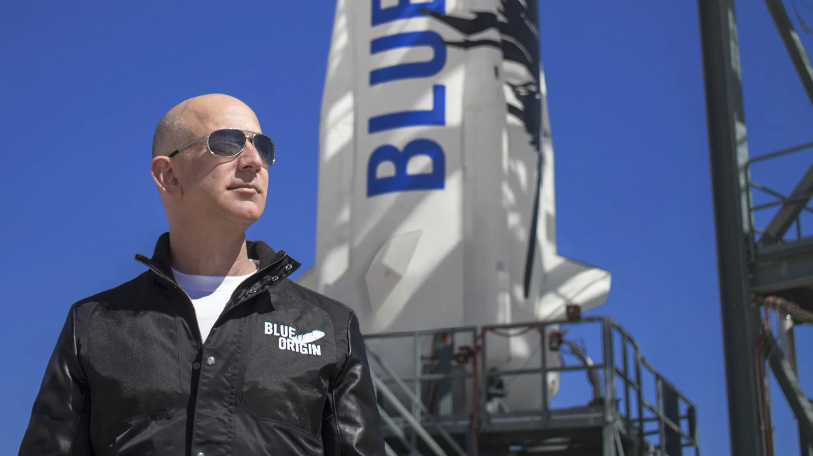 Jeff Bezos at the Blue Origin launch pad with a New Shepard rocket. Credit Blue Origin