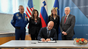 Matevž Frangež, State Secretary, Ministry of Economy, Tourism, and Sport signs the Artemis Accords on behalf of Slovenia with NASA astronaut Randy Bresnik, Ambassador Jamie L. Harpootlian, Rebecca Bresnik, Associate General Counsel for International and Space Law, and Slovenian Ambassador to the United States Iztok Mirošič standing behind.