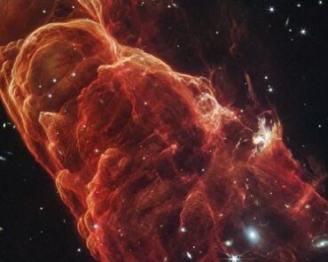 Webb Space Telescope Image Reveals Herbig-Haro 49/50 and Spiral Galaxy