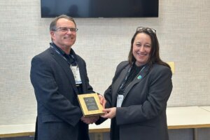 SIG Director, Angela Wheeler presenting the Innovation of the Year award to Steve Richeson, Mission Microwave Technologies.