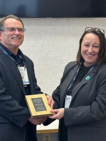 SIG Director, Angela Wheeler presenting the Innovation of the Year award to Steve Richeson, Mission Microwave Technologies.
