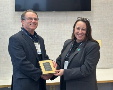SIG Director, Angela Wheeler presenting the Innovation of the Year award to Steve Richeson, Mission Microwave Technologies.