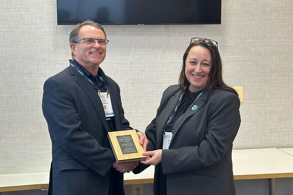 SIG Director, Angela Wheeler presenting the Innovation of the Year award to Steve Richeson, Mission Microwave Technologies.