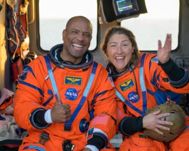 NASA astronaut Victor Glover, Artemis II pilot, left, and NASA astronaut Christina Koch, Artemis II mission specialist are seen sitting on a Navy MH-60 Seahawk from Helicopter Sea Combat Squadron (HSC) 23 on the flight deck of USS John P. Murtha after they and fellow crewmates CSA (Canadian Space Agency) astronaut Jeremy Hansen, Artemis II mission specialist, and NASA astronaut Reid Wiseman, Artemis II commander, were extracted from their Orion spacecraft after splashdown, Friday, April 10, 2026, in the Pacific Ocean off the coast of California. NASA’s Artemis II mission took the quartet on a nearly 10-day journey around the Moon and back to Earth. Following a splashdown at 5:07 p.m. PDT (8:07 p.m. EDT), NASA, U.S. Navy, and U.S. Air Force teams are working to bring the Orion spacecraft aboard the recovery ship. Photo Credit: (NASA/Bill Ingalls)