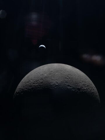 The Artemis II crew captures a faint view of a crescent Earth above the horizon on the Moon’s far side. Credit: NASA
