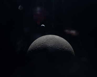 The Artemis II crew captures a faint view of a crescent Earth above the horizon on the Moon’s far side. Credit: NASA